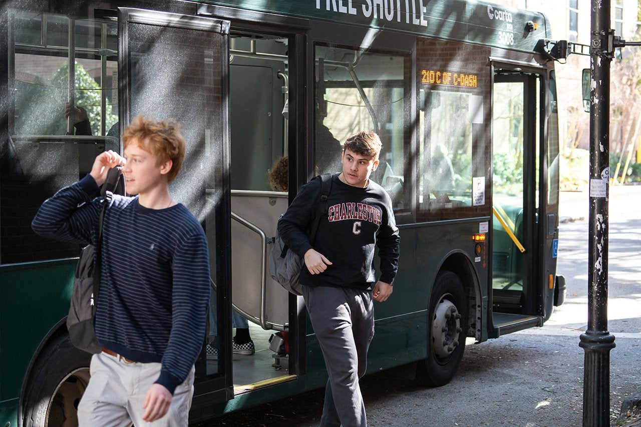 students gets off bus with Charleston sweatshirt