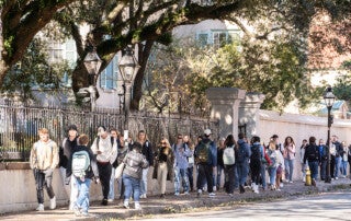 large groups of students walk to their first day of classes after winter break