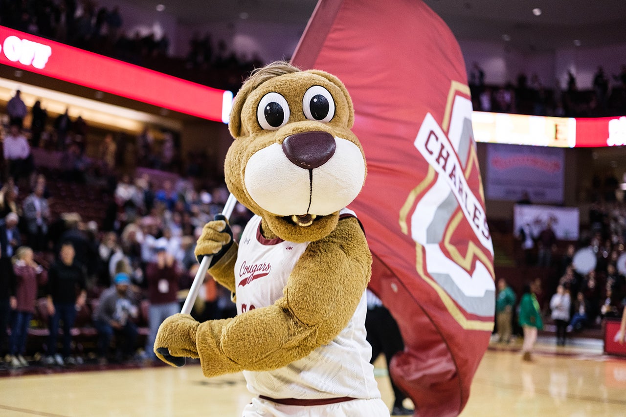 Clyde the Cougar waves the flag at the basketball game