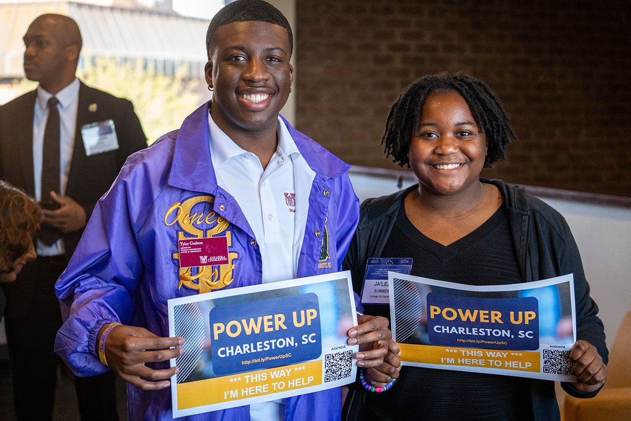 Students pose with Power Up signage